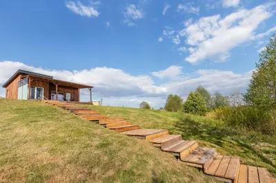 a set of steps on a hill with a building at Pineplace twins Smilga in Žaugėdai