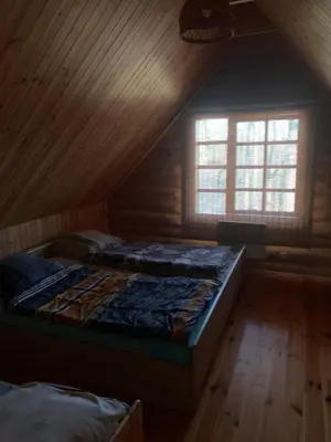 a bedroom with a large bed in a attic at Poilsis ant Virintų ežero kranto in Molėtai