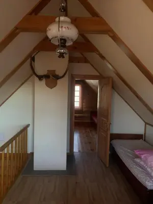 a attic room with a bed and a ceiling at Poilsis ant Virintų ežero kranto in Molėtai