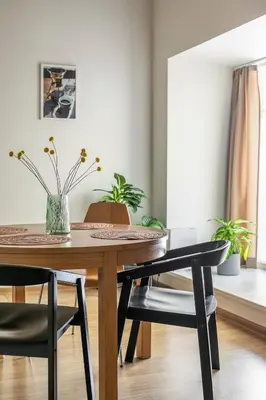 a dining room table and chairs with plants on it at Cozy studio apartment central in Vilnius