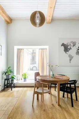 a dining room with a table and a world map on the wall at Cozy studio apartment central in Vilnius