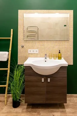 a bathroom with a sink and a mirror at Cozy studio apartment central in Vilnius