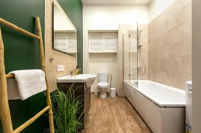 a bathroom with a sink and a tub and a toilet at Cozy studio apartment central in Vilnius