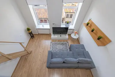 an overhead view of a living room with a couch at New Town loft apartment with air conditioning by Polo Apartments in Kaunas