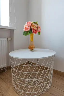 a vase of flowers sitting on top of a table at New Town loft apartment with air conditioning by Polo Apartments in Kaunas