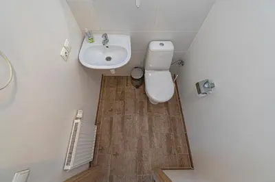 a small bathroom with a toilet and a sink at New Town loft apartment with air conditioning by Polo Apartments in Kaunas