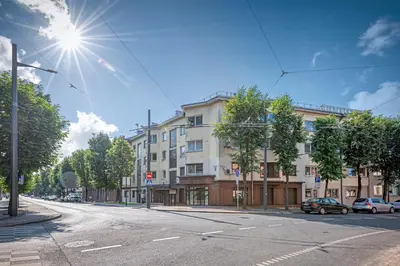 an empty street with cars parked in front of a building at New Town loft apartment with air conditioning by Polo Apartments in Kaunas