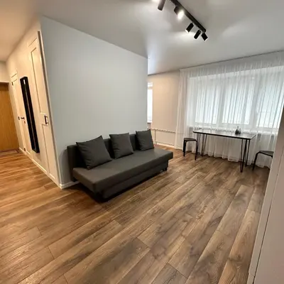 a living room with a couch and a table at Cozy Apartment Kazlų Rūda in Kazlų Rūda