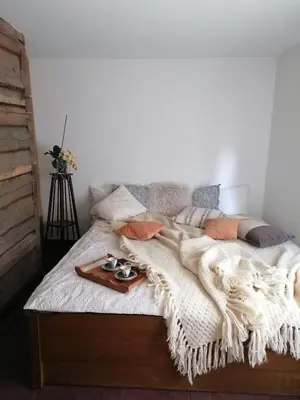 a bed with a tray of food on it at Jono Trobele in Druskininkai