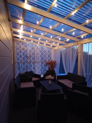 a room with couches and tables and lights at Arimaičių kaimo sodyba in Arimaičiai