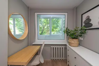 a dining room with a table and a window at Convenient apartment with balcony by Polo Apartments in Kaunas