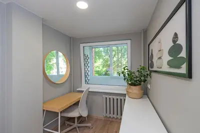 a dining room with a table and a window at Convenient apartment with balcony by Polo Apartments in Kaunas