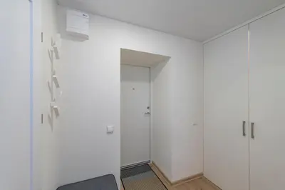 a room with white walls and glass doors at Convenient apartment with balcony by Polo Apartments in Kaunas