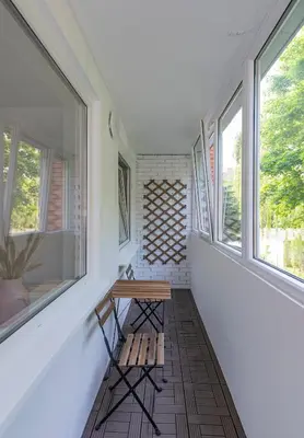 a room with a bench and two windows at Convenient apartment with balcony by Polo Apartments in Kaunas