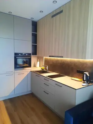 a kitchen with white cabinets and a sink at Ainių gatvės apartamentai in Panevėžys