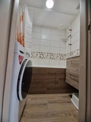 a laundry room with a washer and dryer at Apartamentai Sukileliu pr. in Kaunas