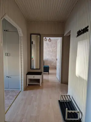 a living room with a mirror and a hallway at Apartamentai Sukileliu pr. in Kaunas