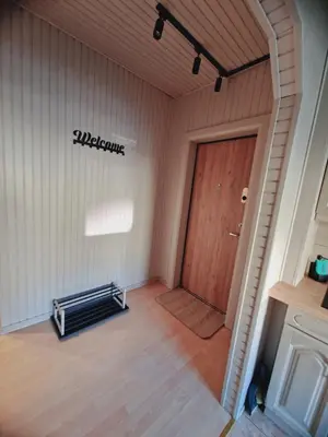 an empty room with a door and a sign that reads welcome at Apartamentai Sukileliu pr. in Kaunas