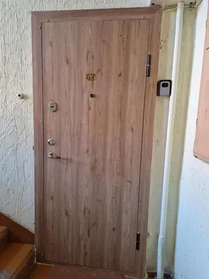 a wooden door with the number on it at Apartamentai Sukileliu pr. in Kaunas