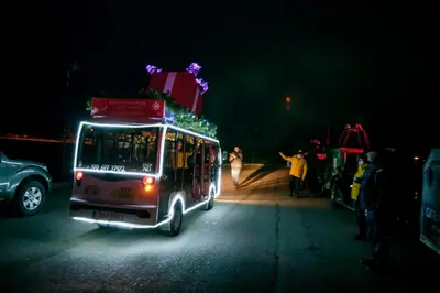 a bus driving down a street at night at Carlo Apartments in Birštonas