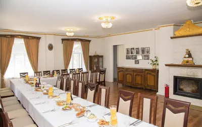 a dining room with a long table and chairs at Skiemonių Dvaras in Skiemonys
