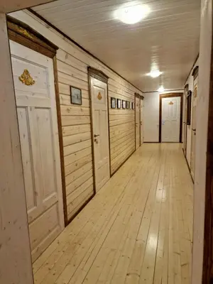 an empty hallway with wood paneled walls and doors at Skiemonių Dvaras in Skiemonys
