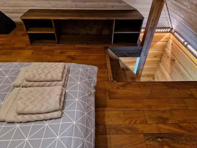 a room with a bed and a wooden floor at Anykščiai MĖNULIO AKMUO in Kavoliškis
