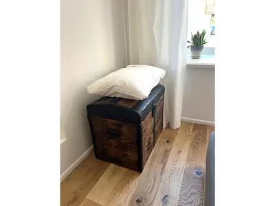 a bed sitting on top of a wooden chest in a room at Cozy studio in Sv Stepono g. in Vilnius