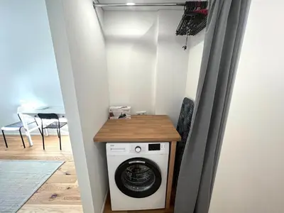 a laundry room with a washer and dryer at Cozy studio in Sv Stepono g. in Vilnius