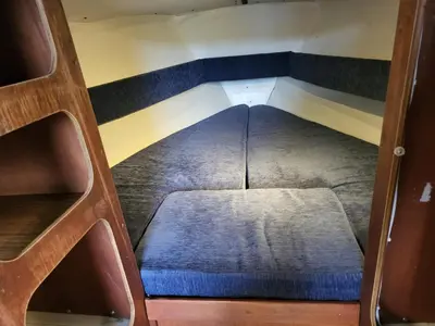 an overhead view of a small bed in a boat at Uždubysio baidarės Nakvynė Jachtose (Night on a Yacht) in Ariogala