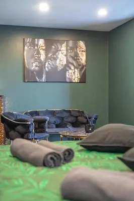 a bedroom with a couch and a bed with pillows at Apartments in Kaunas city centre with Jacuzzi bath in Kaunas