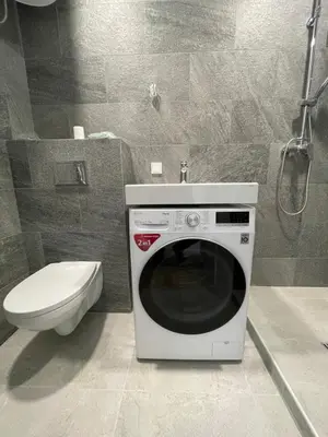 a washing machine in a bathroom with a toilet at 22 Airport Apartment in Vilnius