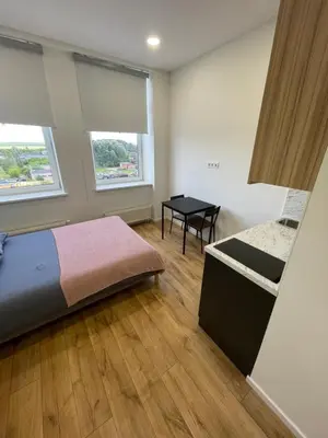 a bedroom with a bed and a table in it at 22 Airport Apartment in Vilnius