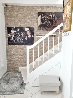 a brick wall with a staircase in a living room at Gallery Balta Apartments in Kaunas