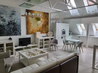 a living room with a couch and a table at Gallery Balta Apartments in Kaunas