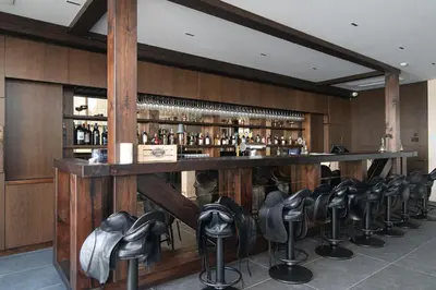 a bar with a row of chairs around it at Royal Horse Resort in Balkasodis
