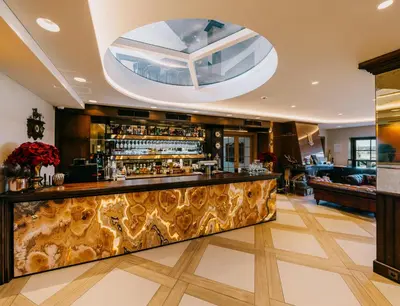 a bar in a hotel lobby with a large window at Royal Horse Resort in Balkasodis