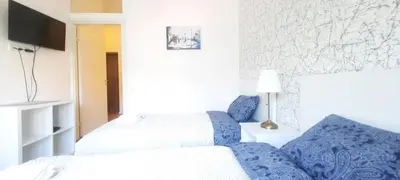 a hotel room with two beds and a tv at Fortress Stay in Kaunas
