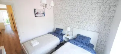 two beds in a room with blue pillows at Fortress Stay in Kaunas
