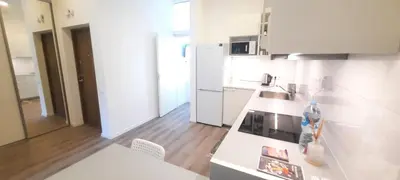a kitchen with white appliances and a white counter top at Fortress Stay in Kaunas