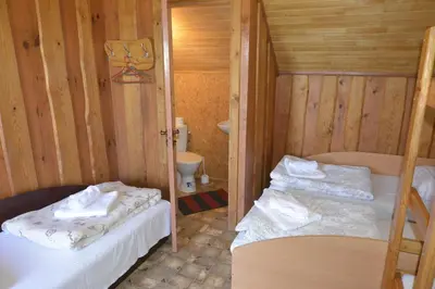 a small room with two bunk beds and a toilet at Šušvė in Plinkaigalis
