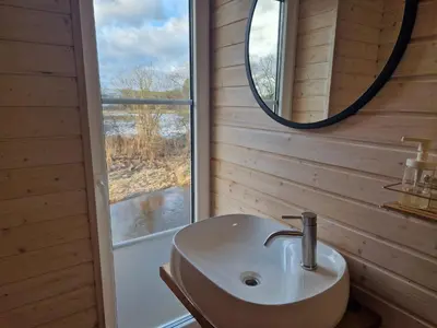 a bathroom with a sink and a mirror at Šušvė in Plinkaigalis