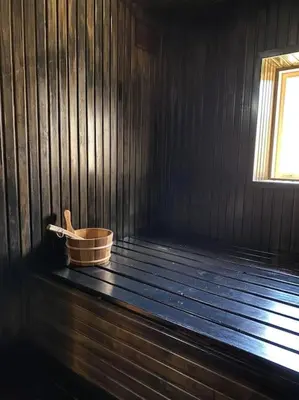 a wooden room with a bucket and a window at Forest springs. Family vacation tennis beach sauna in GratiÅ¡kÄ—s