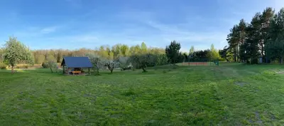 an aerial view of a field with a barn at Forest springs. Family vacation tennis beach sauna in GratiÅ¡kÄ—s