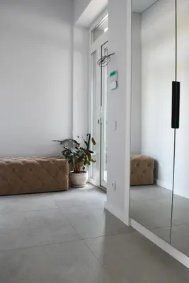 a hallway with a couch and a glass door at Koala rest house in Druskininkai