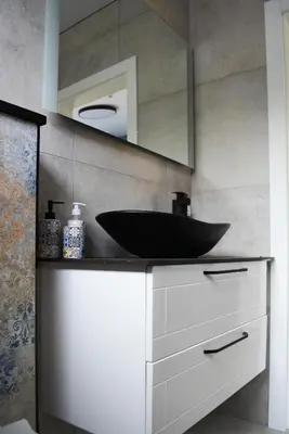 a bathroom with a black sink and a mirror at Koala rest house in Druskininkai