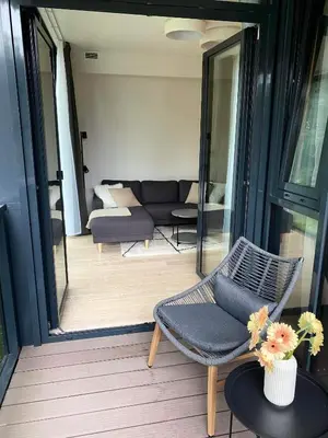 a living room with a couch and a chair at Apartment-Pine Forest Birštonas in Birštonas