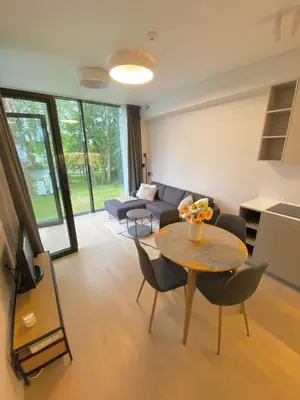 a living room with a table and a couch at Apartment-Pine Forest Birštonas in Birštonas