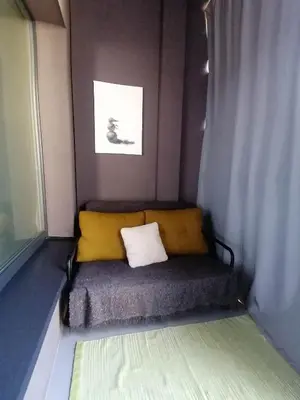 a small bed in a room with a window at Erdvi studija Spacious studio apartment Self check in in Vilnius