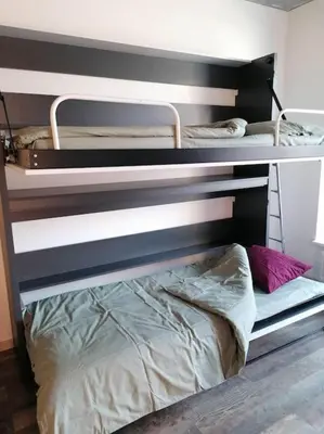 a couple of bunk beds in a room at Erdvi studija Spacious studio apartment Self check in in Vilnius